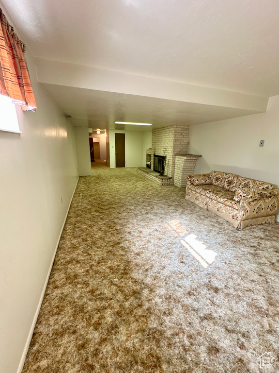 Unfurnished living room with carpet floors and a fireplace