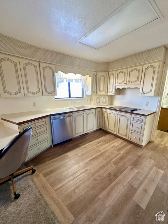 Kitchen with dishwasher, a sink, cream cabinetry, black electric cooktop, and light wood-type flooring