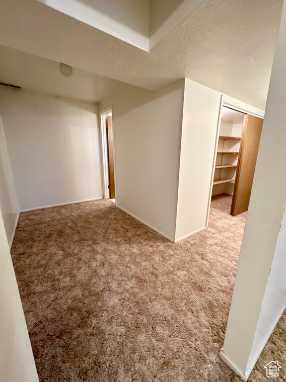 Carpeted spare room with baseboards and a textured ceiling