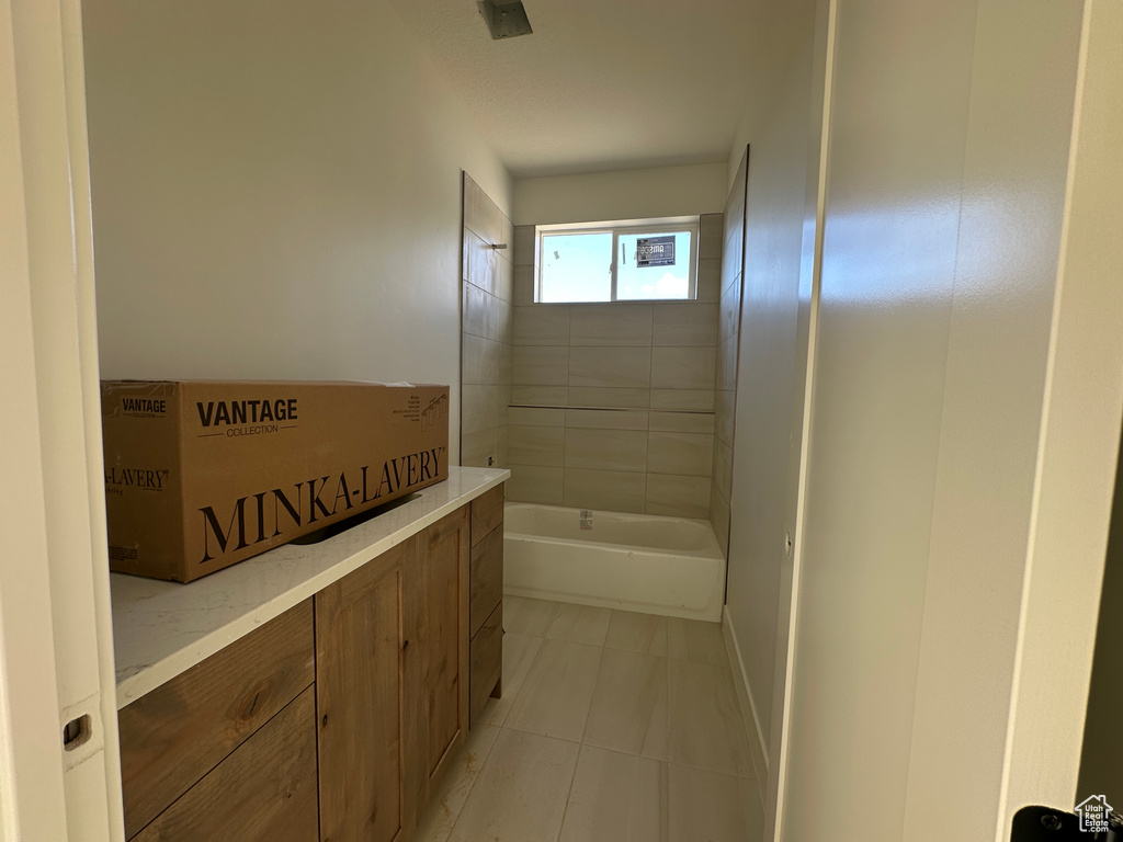 Bathroom with tile patterned floors and bathing tub / shower combination