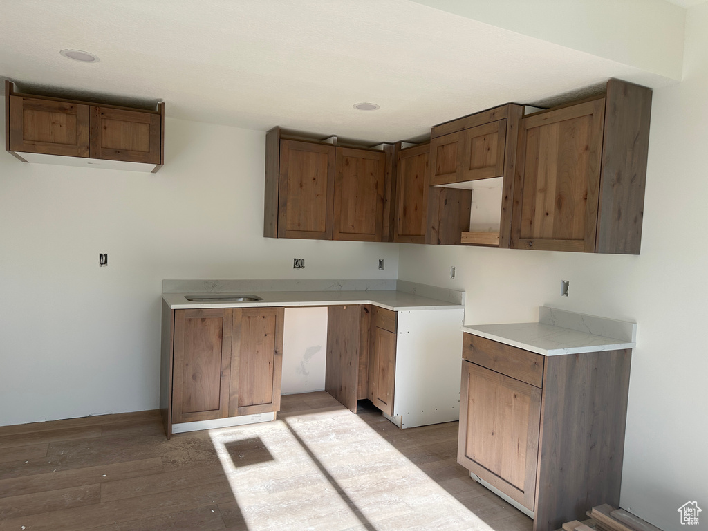 Kitchen featuring light wood-style floors, brown cabinets, and recessed lighting