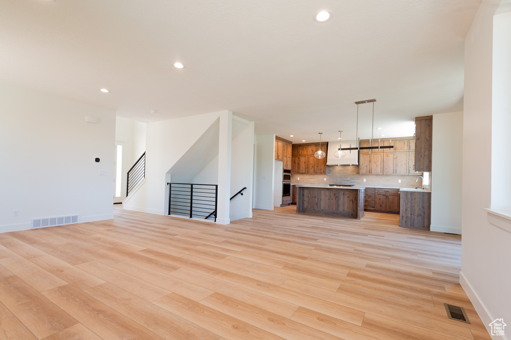 Unfurnished living room with light wood-style floors and recessed lighting