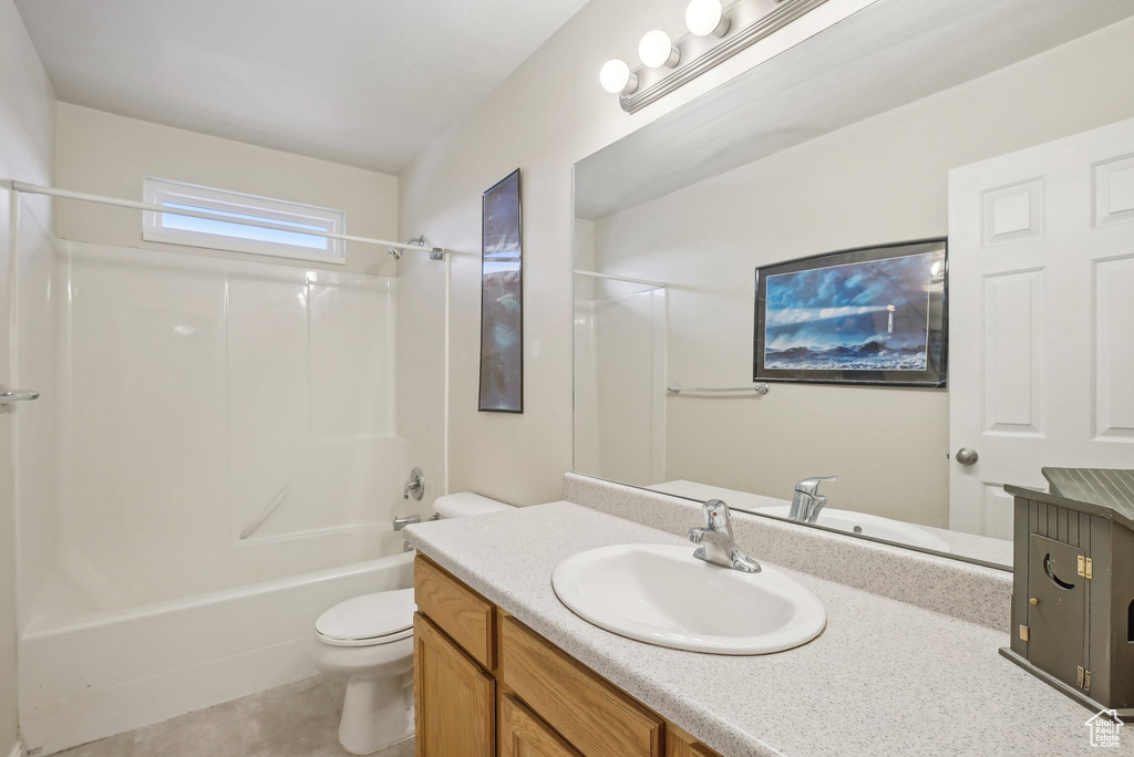 Full bath with toilet, vanity, bathtub / shower combination, and tile patterned flooring