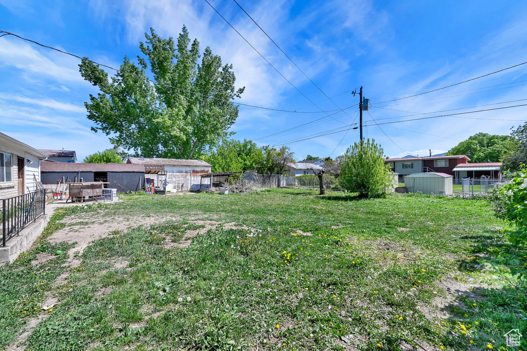 View of yard with a storage shed and an outdoor structure