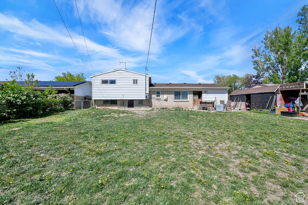 Back of property featuring a patio and brick siding