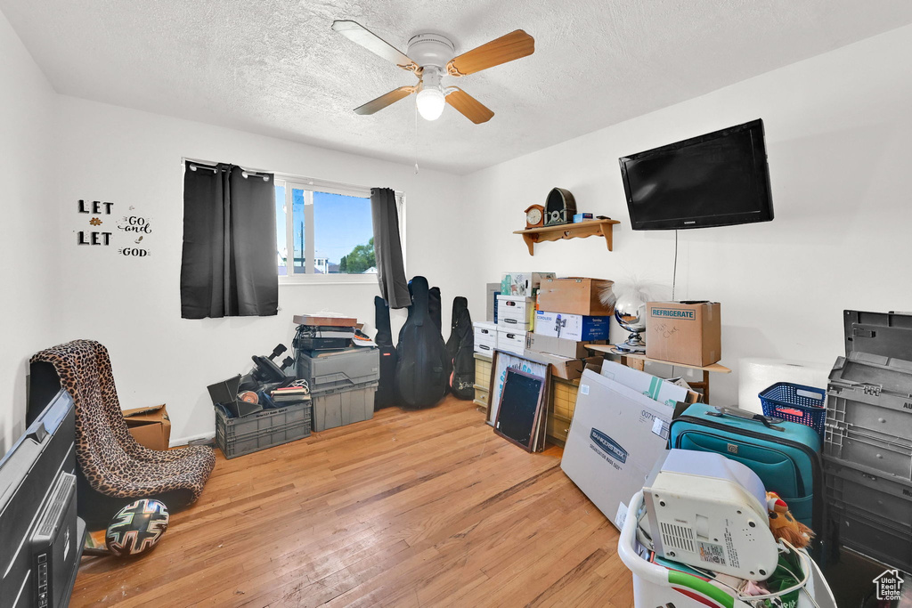 Office area featuring wood finished floors, a ceiling fan, and a textured ceiling
