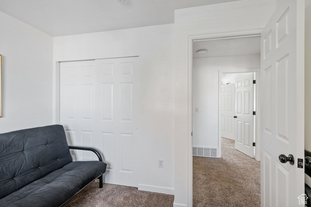 Sitting room with carpet flooring and baseboards
