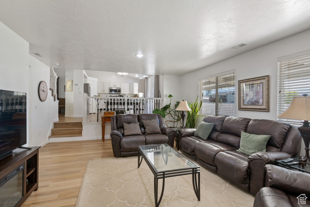 Living room featuring light wood-type flooring and baseboards