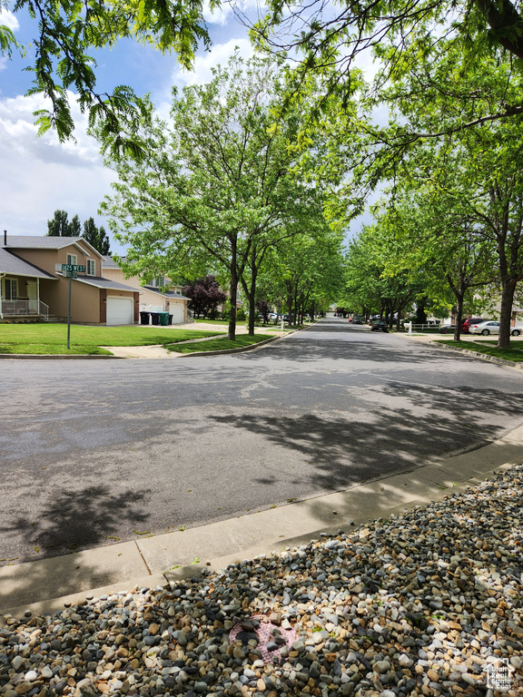 View of asphalt road with curbs