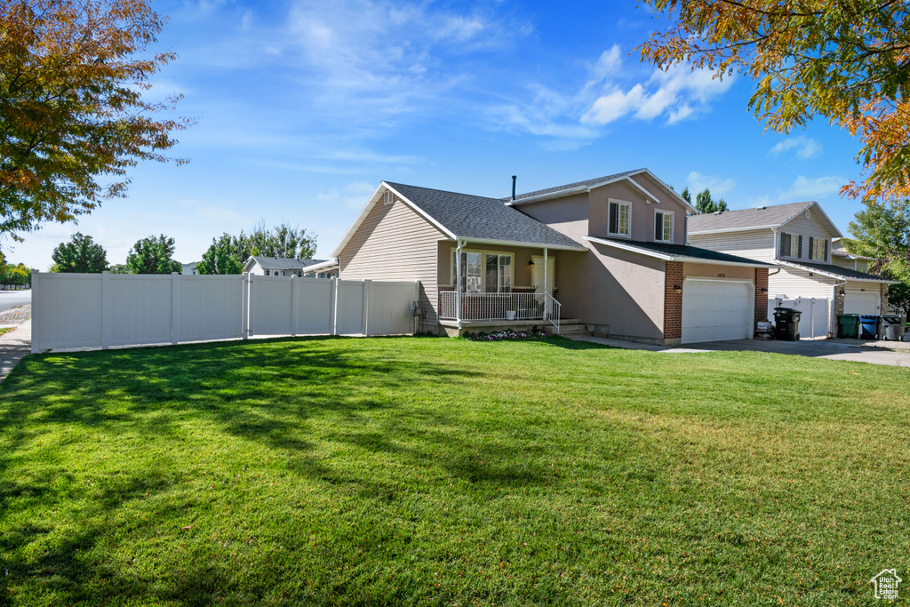 Split level home featuring a porch and driveway