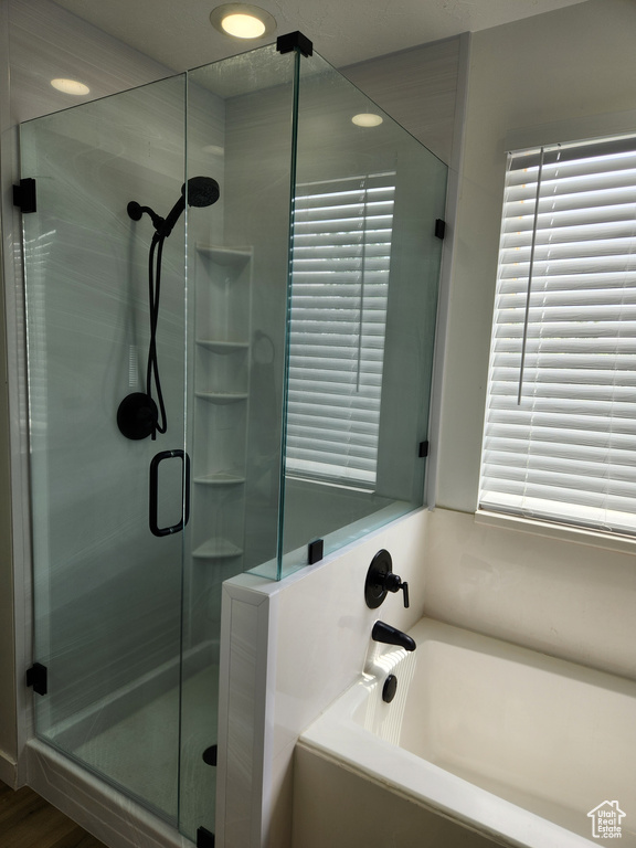 Full bath with a garden tub and a shower stall
