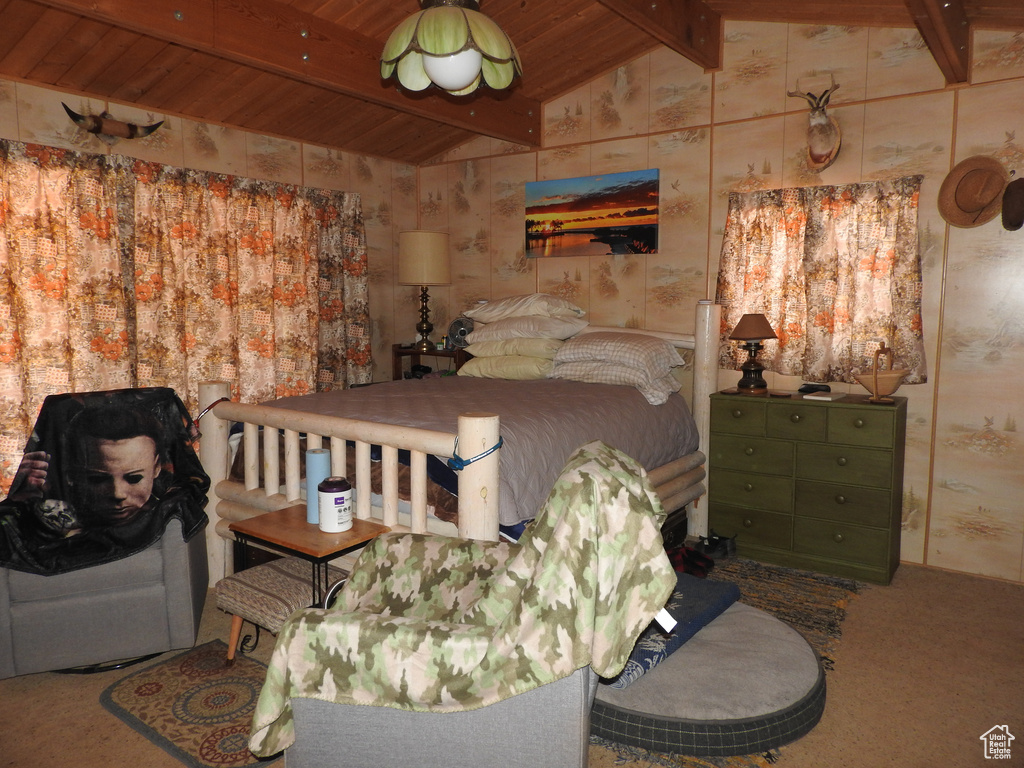 Bedroom with carpet flooring, wooden ceiling, and wallpapered walls