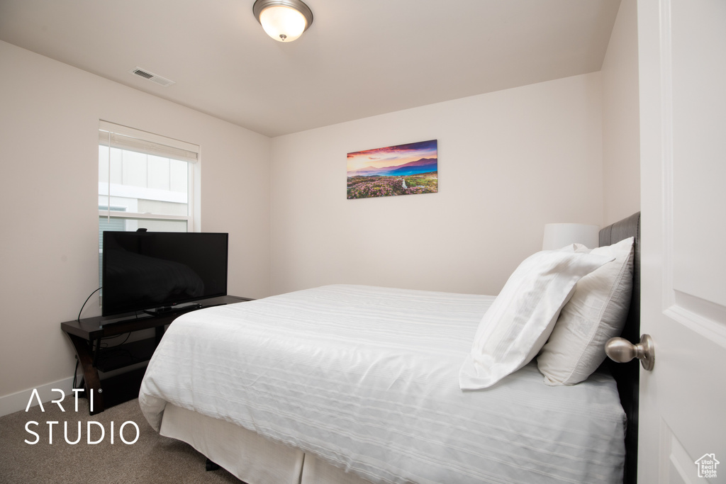 Carpeted bedroom with baseboards