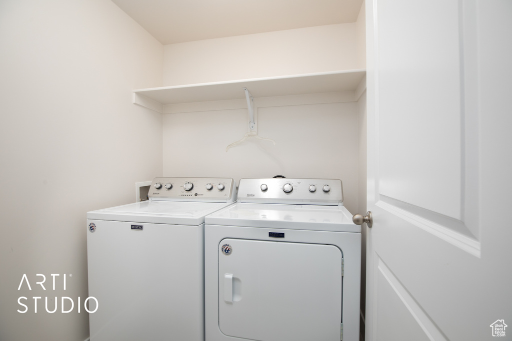 Clothes washing area featuring separate washer and dryer