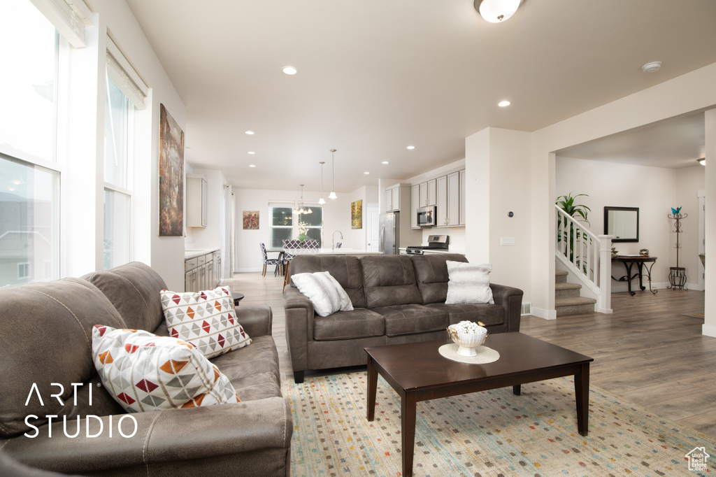 Living area featuring light wood finished floors, recessed lighting, and baseboards