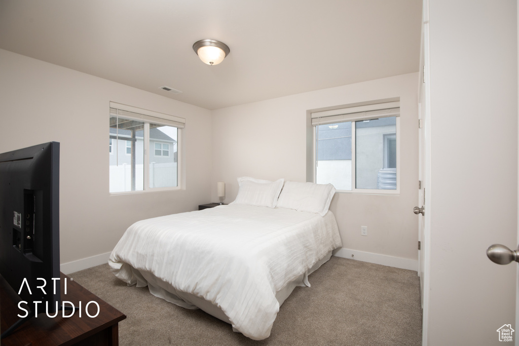 Bedroom with baseboards and carpet