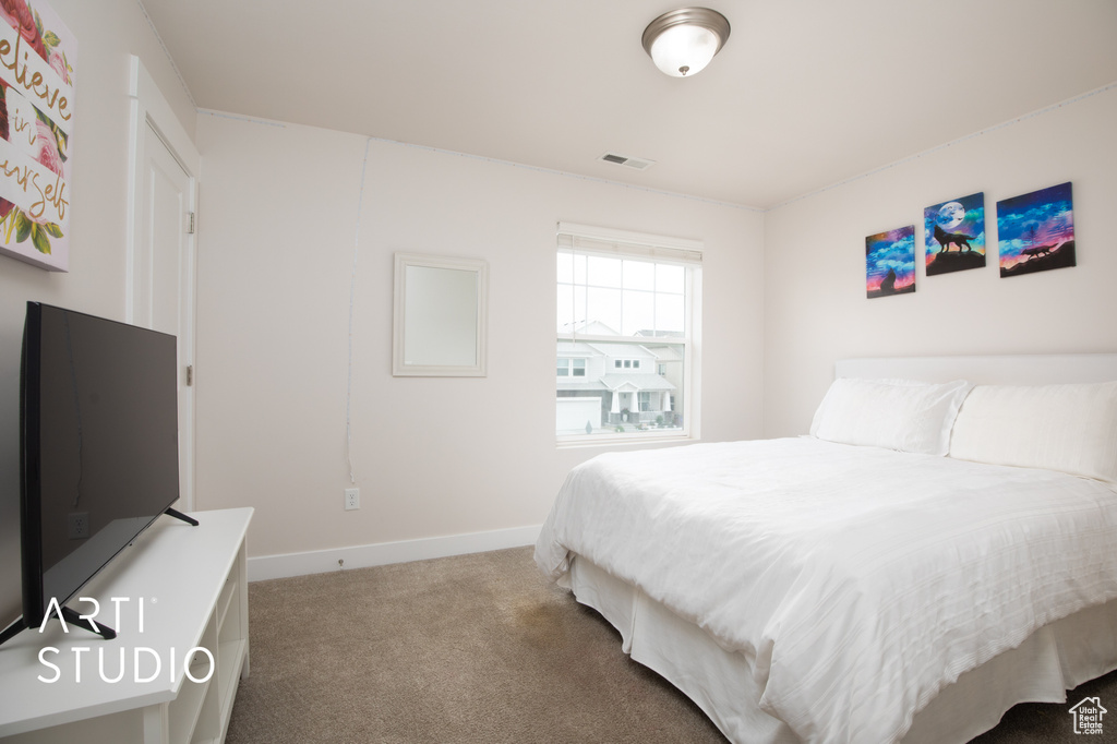 Carpeted bedroom featuring baseboards