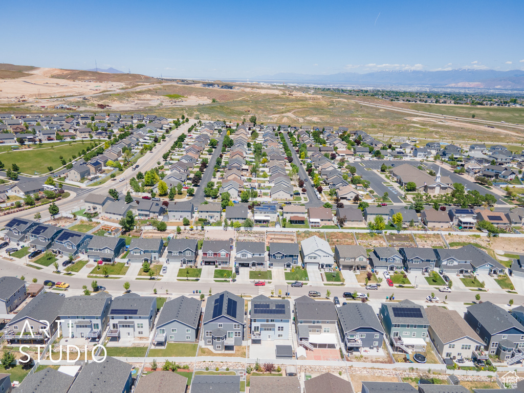 Aerial view of property and surrounding area featuring nearby suburban area