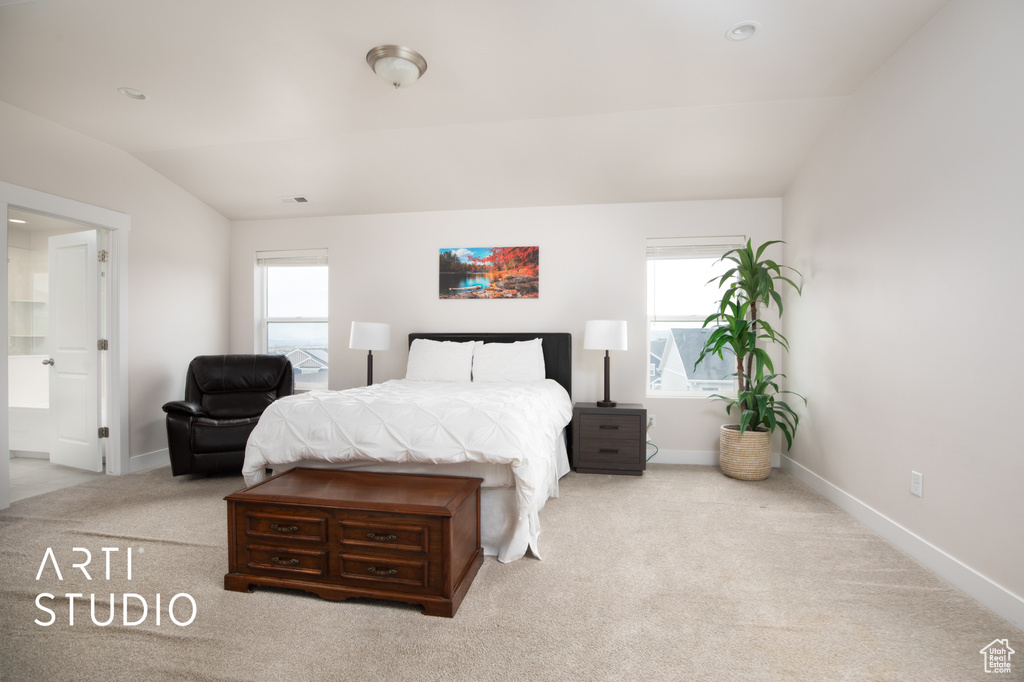 Bedroom featuring multiple windows, lofted ceiling, carpet floors, and baseboards