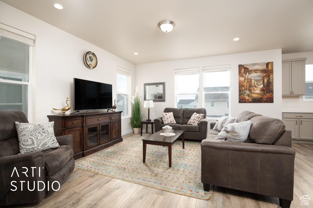 Living area featuring light wood finished floors and recessed lighting