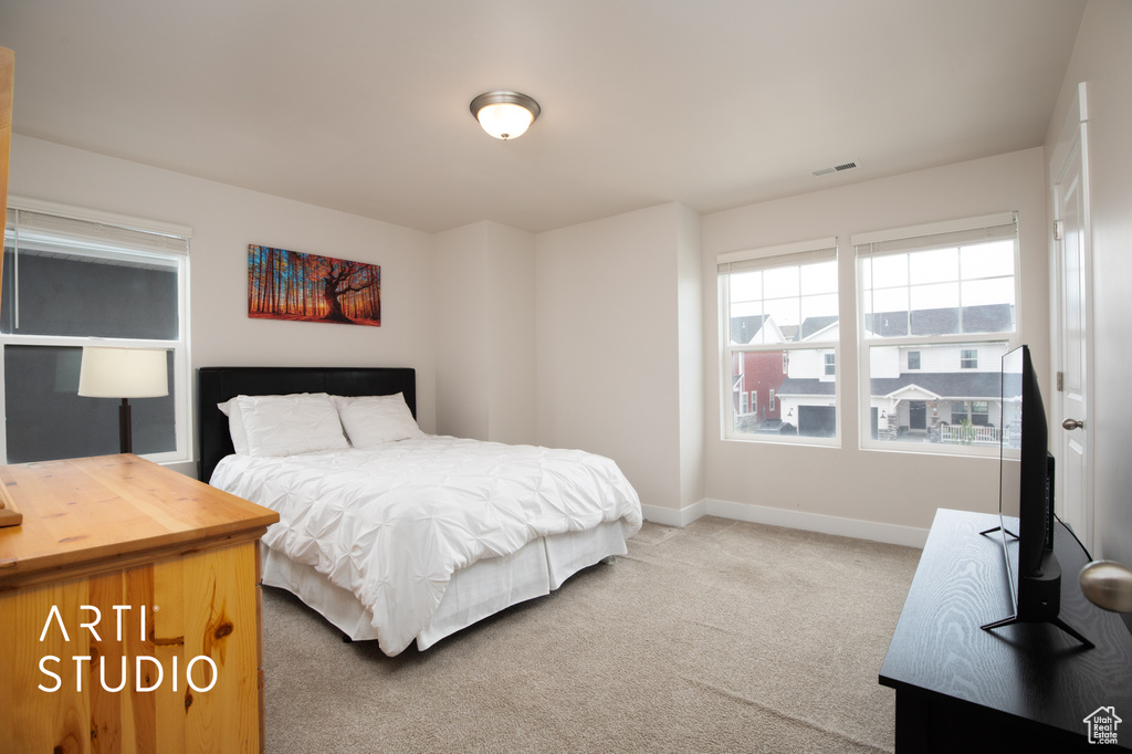 Carpeted bedroom featuring baseboards