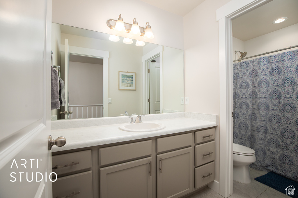 Bathroom with vanity, toilet, tile patterned flooring, and a shower with curtain