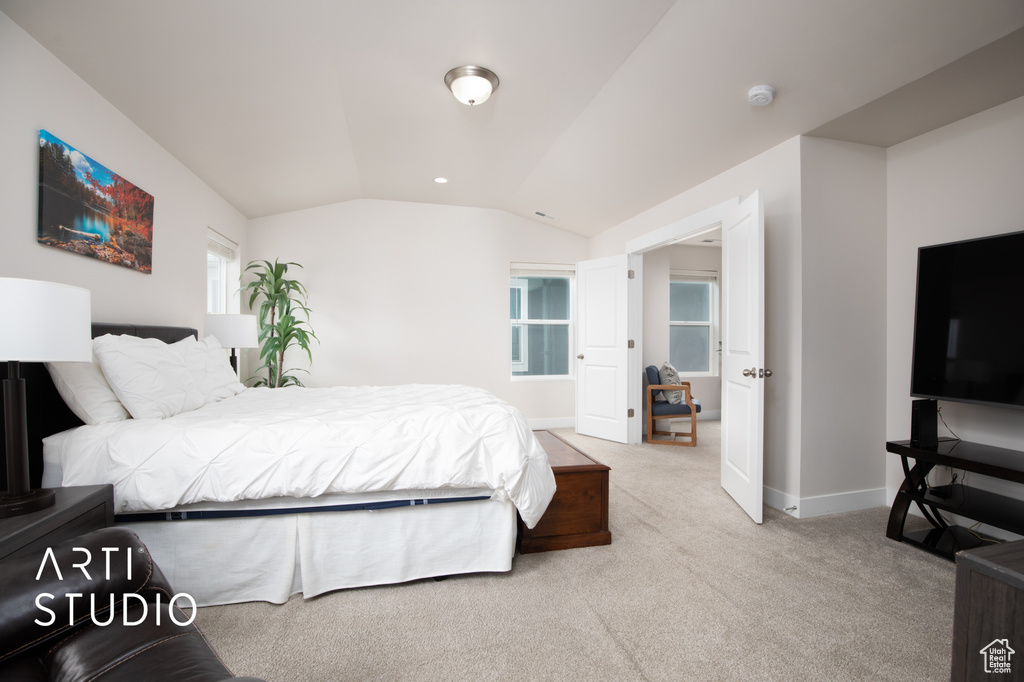 Bedroom with lofted ceiling, baseboards, and carpet floors