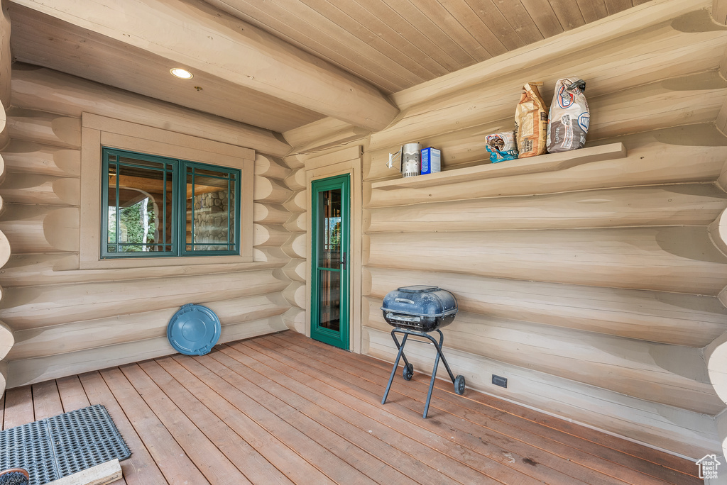 Wooden terrace featuring covered porch