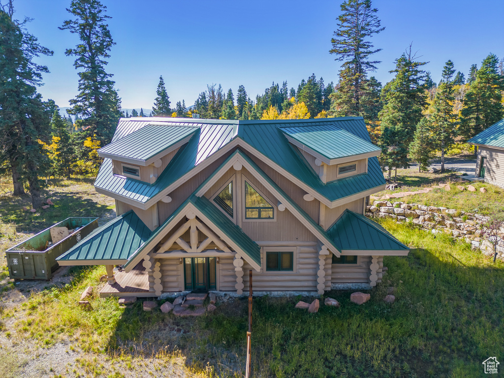 Log-style house featuring log exterior, metal roof, and a standing seam roof