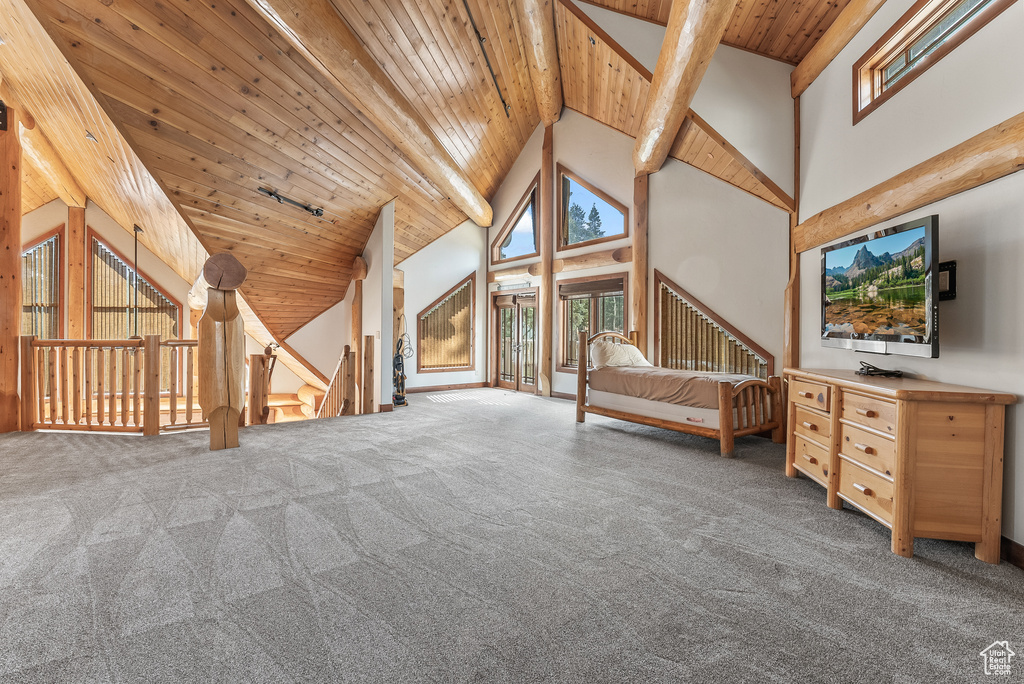 Unfurnished bedroom with wooden ceiling, carpet flooring, high vaulted ceiling, and beam ceiling