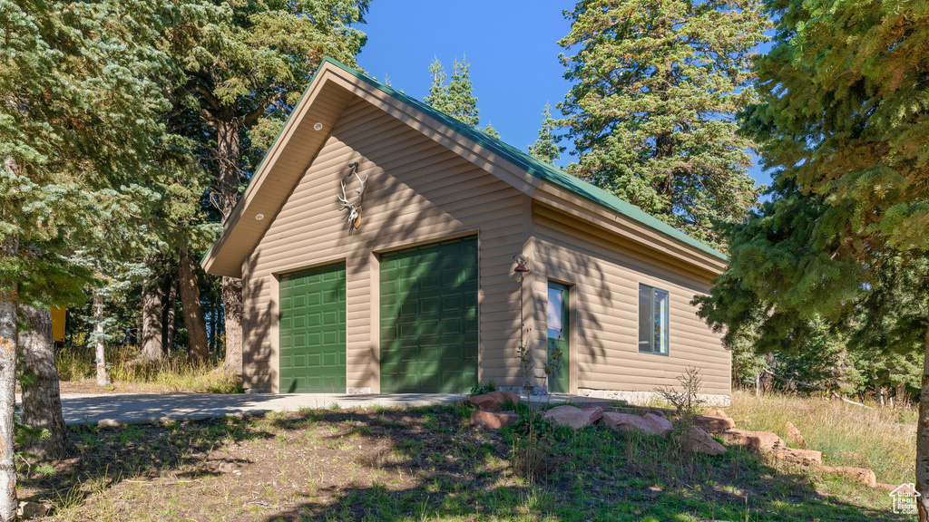 View of home\'s exterior featuring an outdoor structure and a detached garage