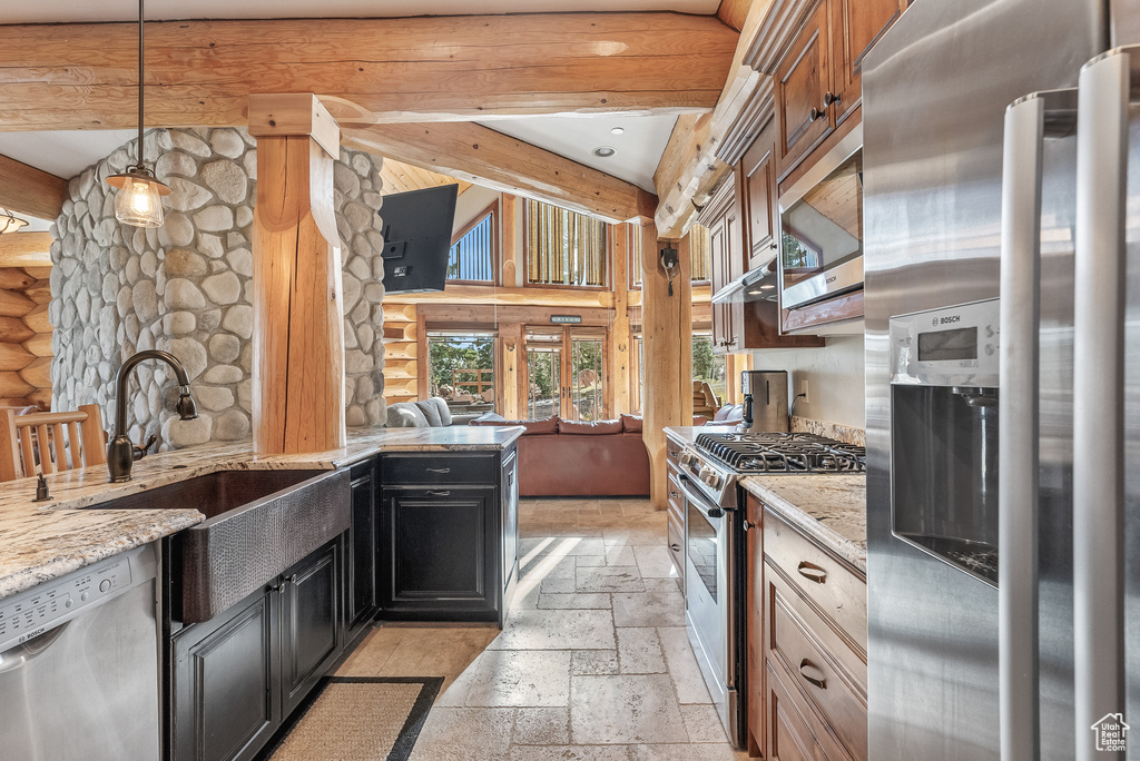Kitchen with a sink, stainless steel appliances, stone tile floors, log walls, and beamed ceiling