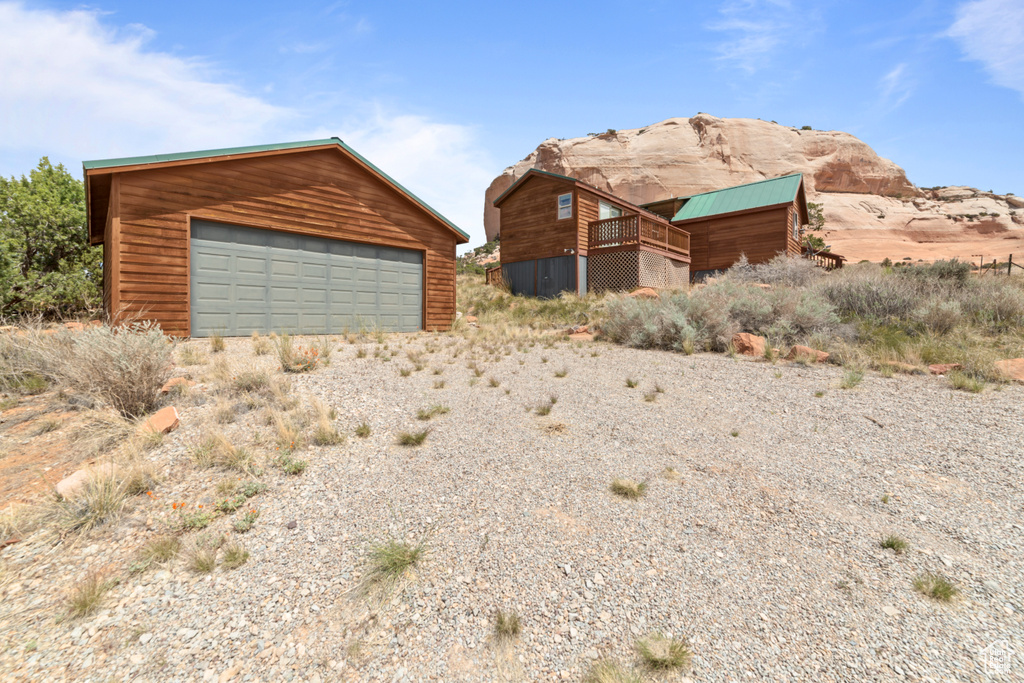 View of front of house with an outbuilding and a detached garage