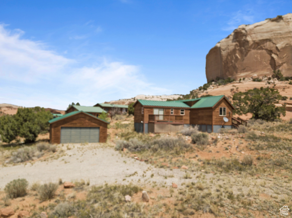 View of front facade with an outdoor structure and dirt driveway