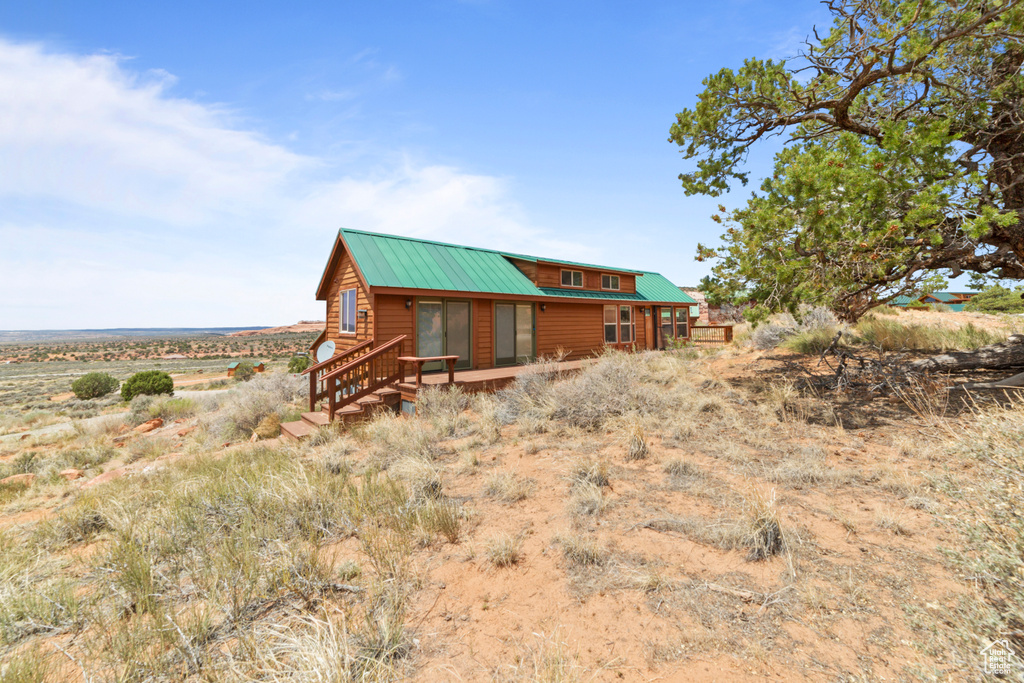 Rear view of property featuring metal roof