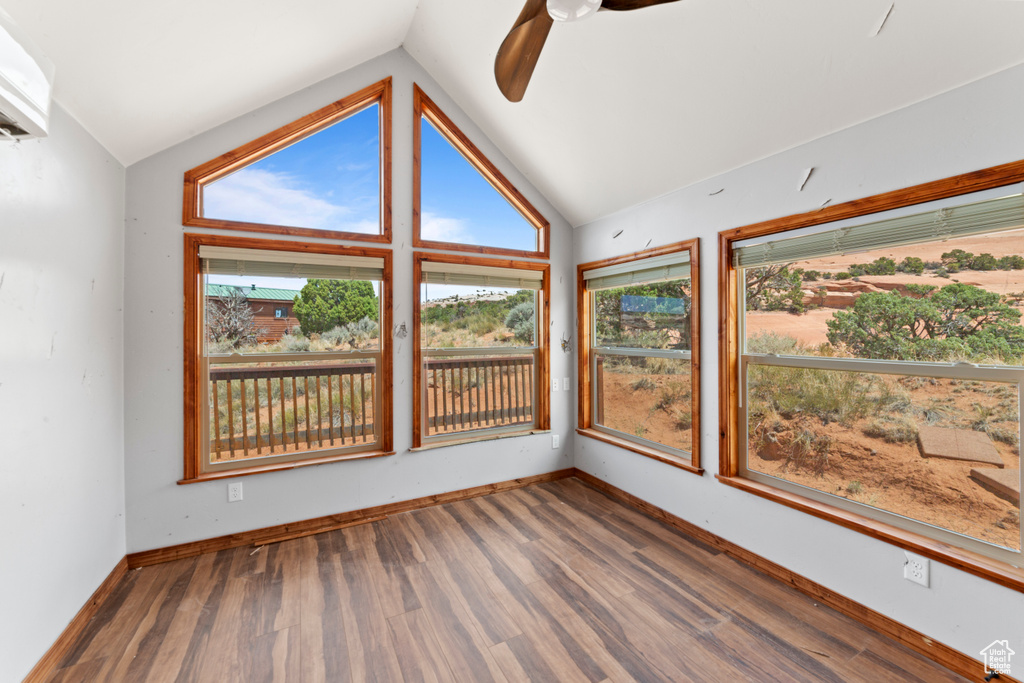 Unfurnished sunroom with vaulted ceiling and plenty of natural light