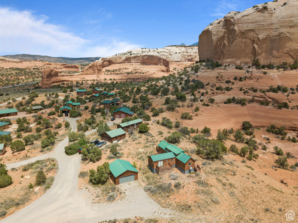 Aerial view of property and surrounding area with a desert landscape, a mountain backdrop, and rural landscape