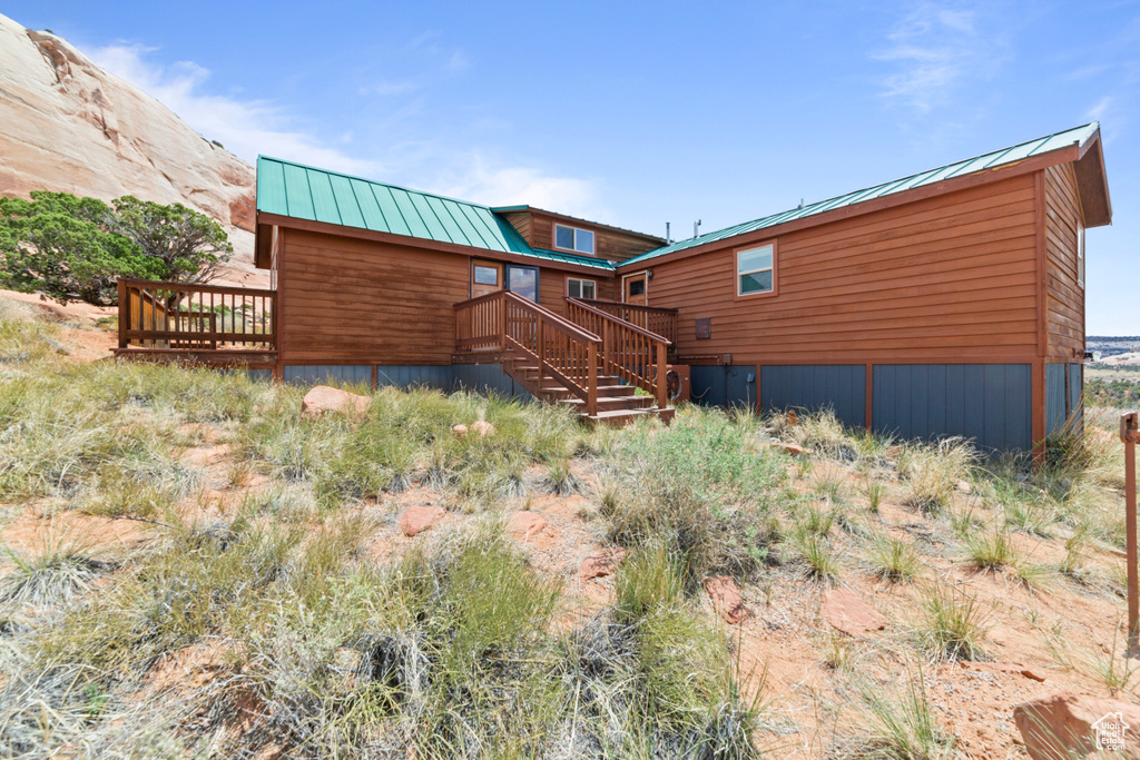 Rear view of house with a deck and metal roof