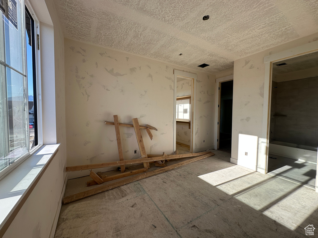 Unfurnished bedroom featuring a textured ceiling