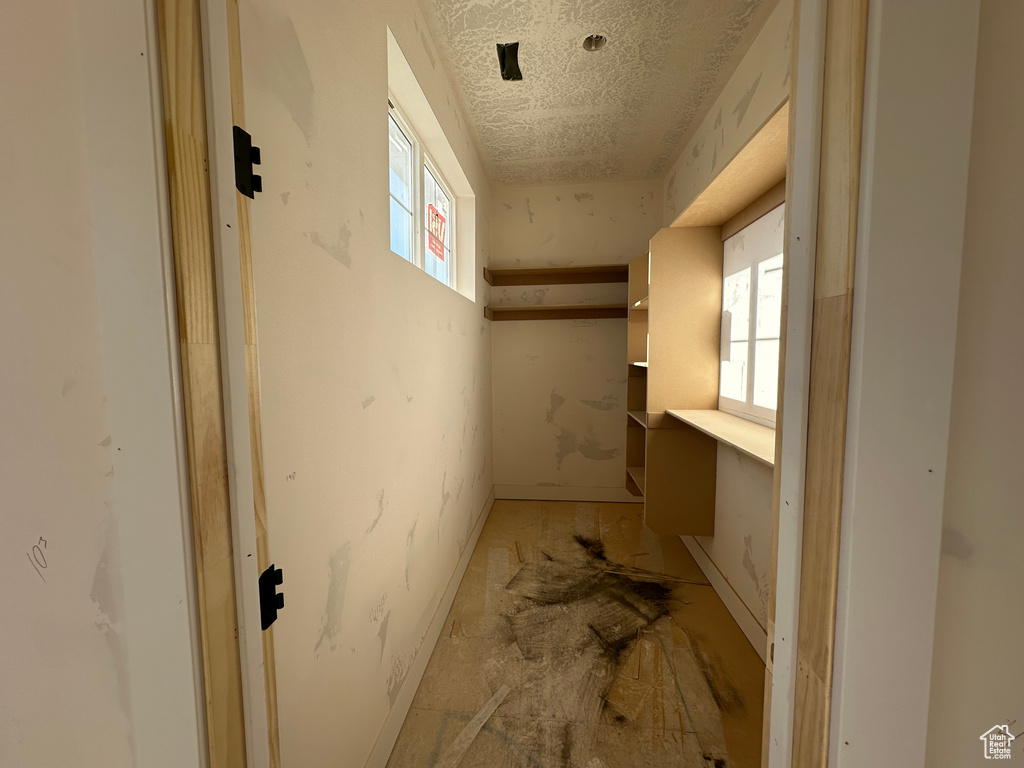 Basement featuring a textured ceiling