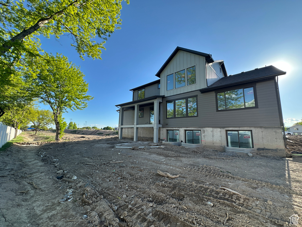 Rear view of property with board and batten siding