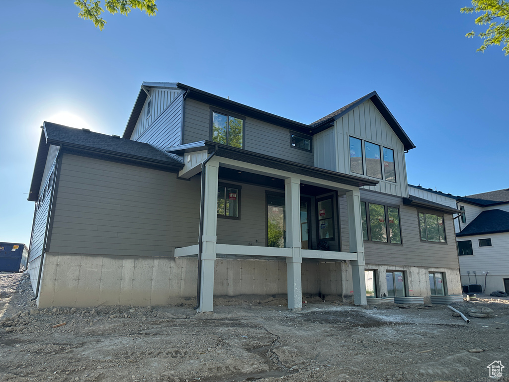 Rear view of house featuring board and batten siding