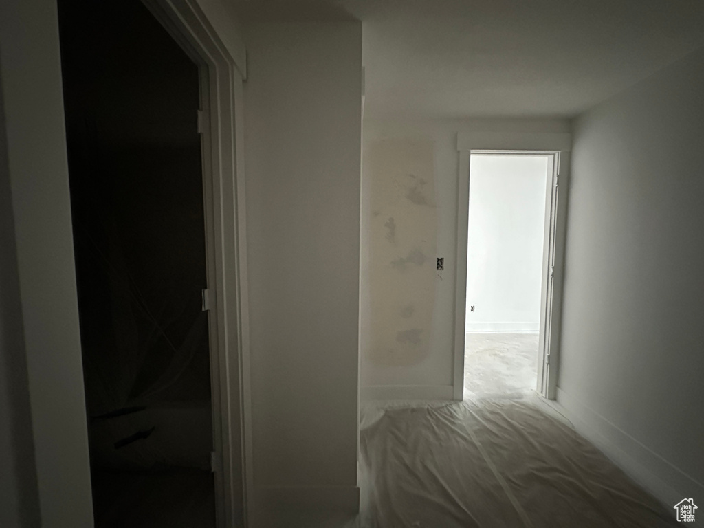 Hall with carpet and baseboards