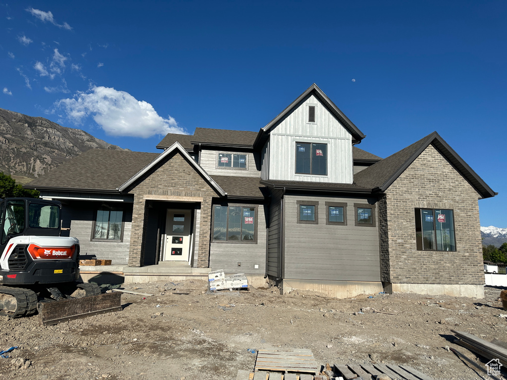 View of front of property featuring brick siding and a mountain view
