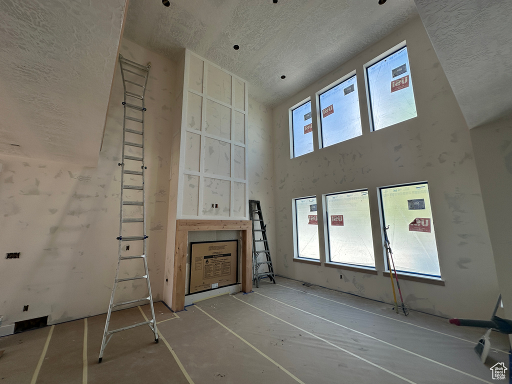 Unfurnished living room featuring a textured ceiling