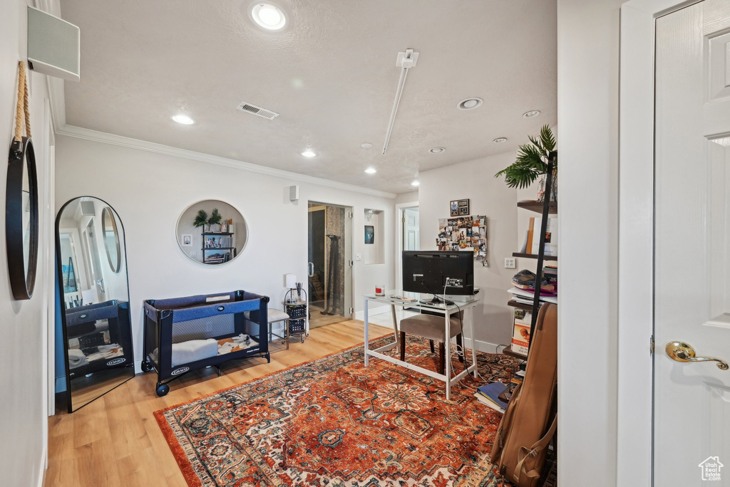 Office area featuring light wood-type flooring, ornamental molding, recessed lighting, and baseboards