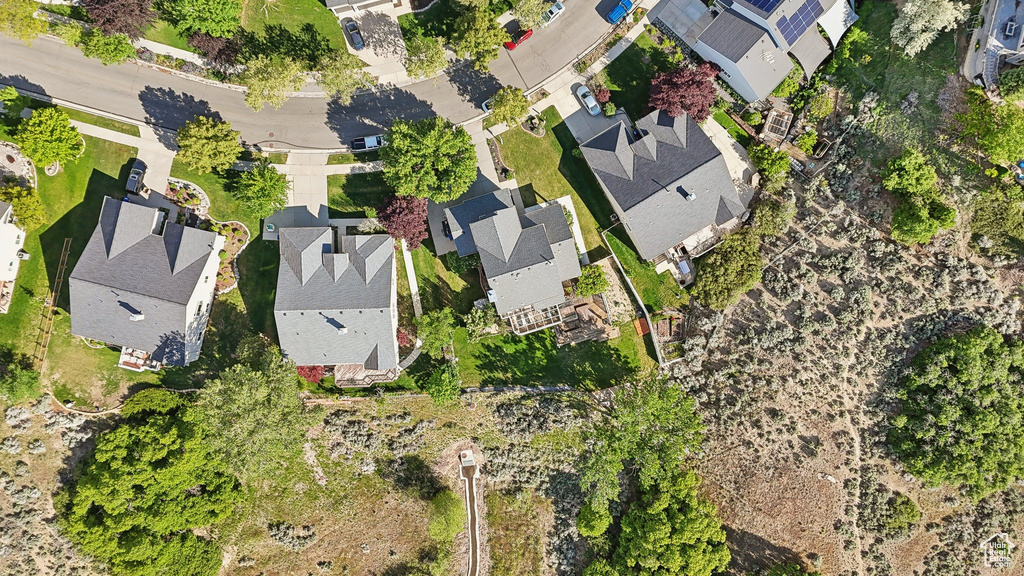 Aerial view of property and surrounding area with nearby suburban area