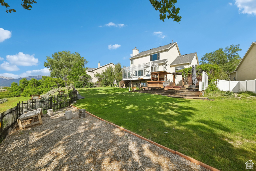 View of yard featuring a deck with mountain view