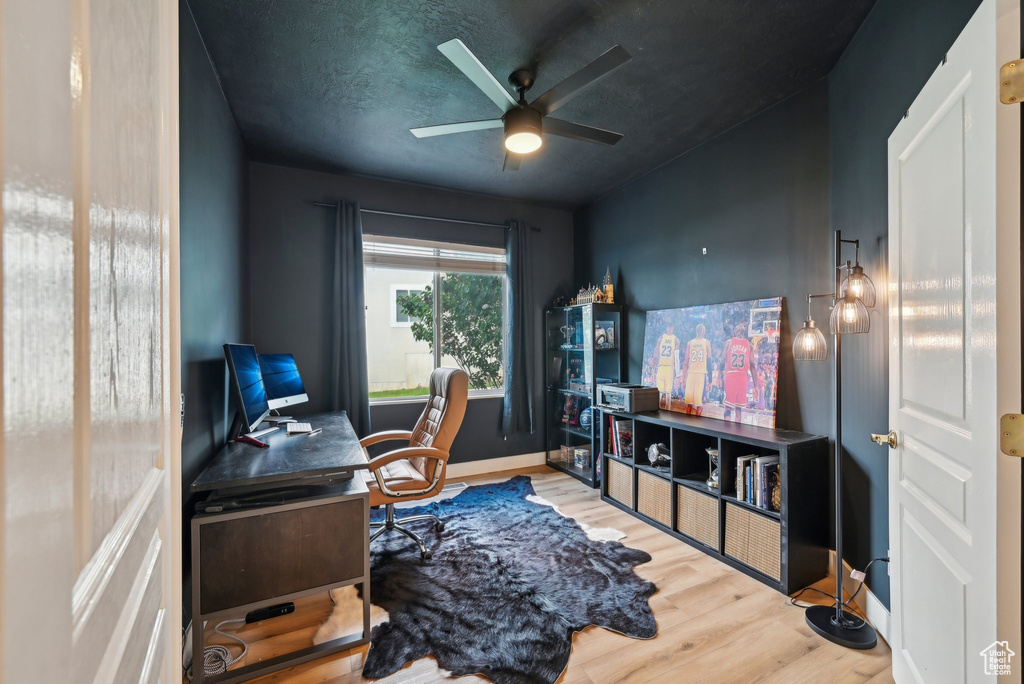 Office with wood finished floors, ceiling fan, and baseboards