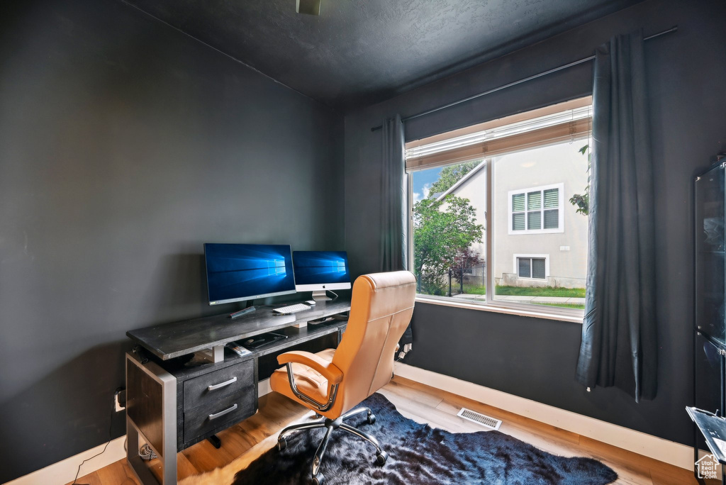 Office area featuring wood finished floors and baseboards